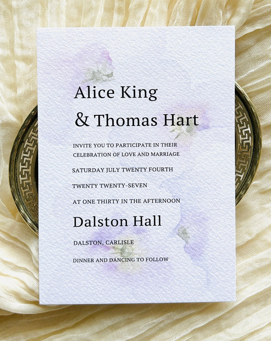 Wedding invitation card with a soft, watercolour floral decoration and a modern font

